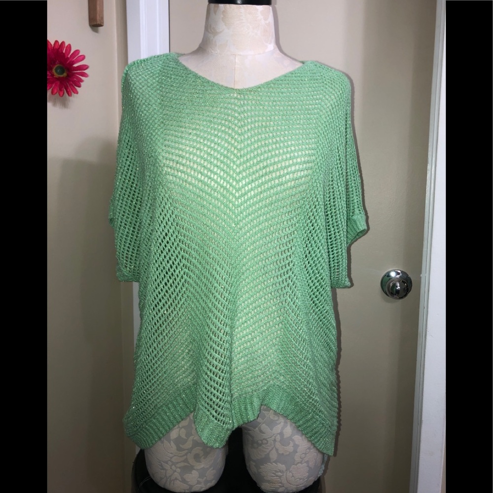 Light green, short-sleeved, netted sweater sprinkled with hints of sparkle.